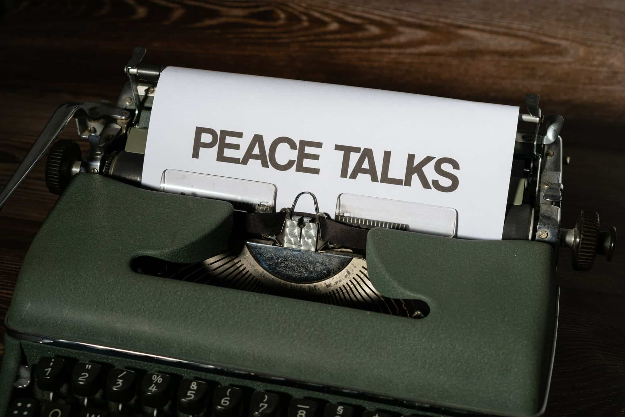Photo of a typewriter writing 'peace talks' on a paper